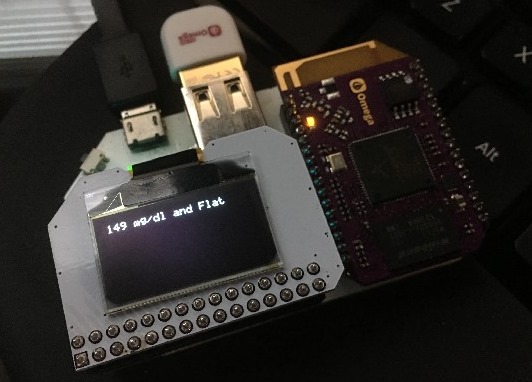 The OLED Screen says "149 mg/dl and Flat"
